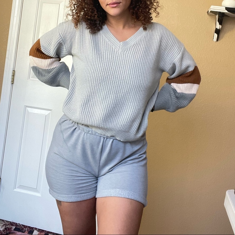 Grey knit v neck sweatshirt with brown and tan arm stripes